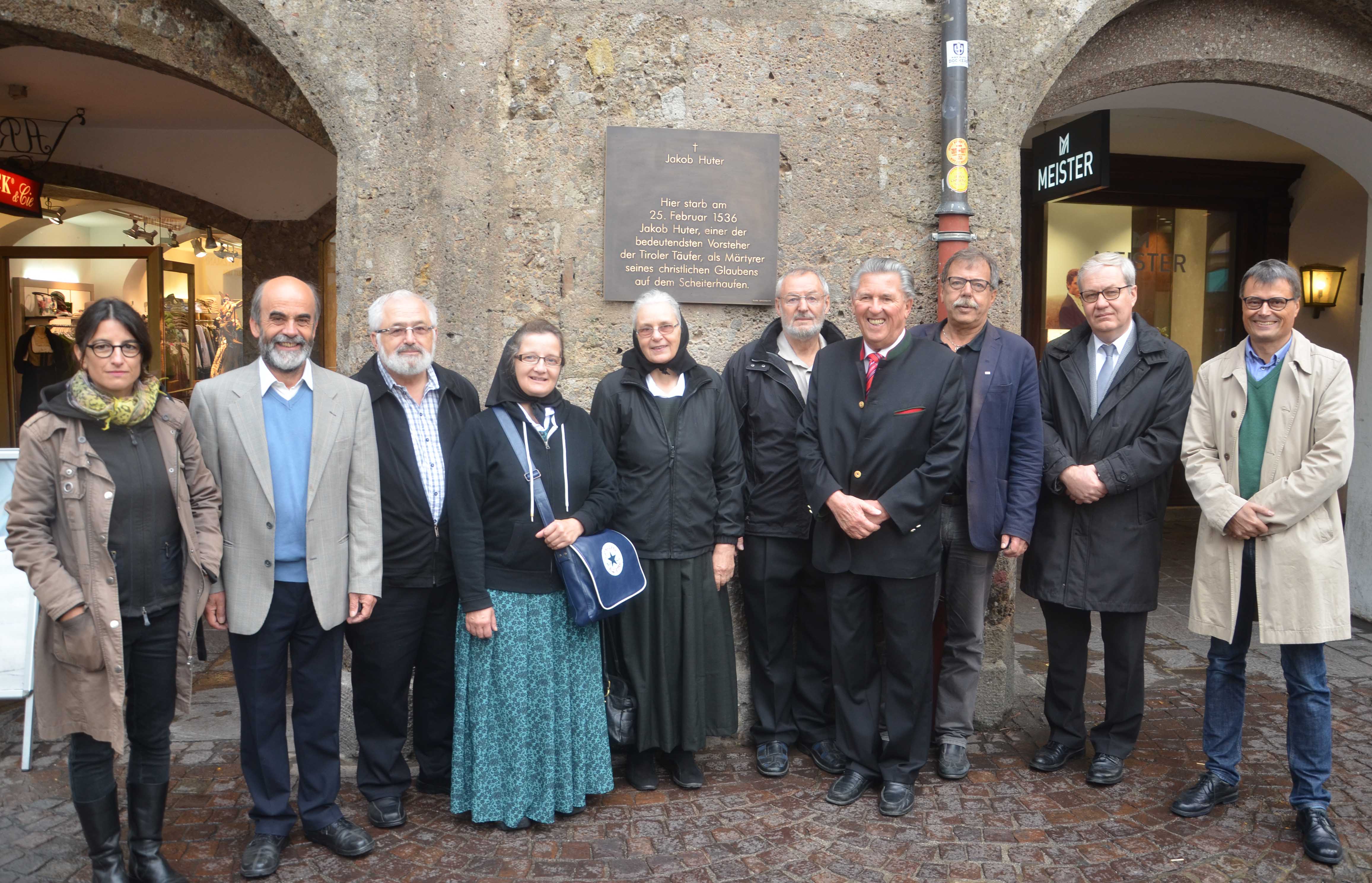 Bei der Anbringung der neuen Gedenktafel an Jakob Huter am Goldenen Dachl (v.l.): Künstlerin Verena Simeoni, Robert Hochgruber (Vorsitzender des Hutterer Arbeitskreises), VertreterInnen der kanadischen Hutterer Gemeinschaft rund um Prediger Edward Kleinsasser (Crystal Spring Colony, 5.v.r.), Christof Grassmayr, der für die Produktion der Tafel zuständig war, Stadtrat Gerhard Fritz, Christoph Haidacher (Landesarchivdirektor) und Eduard Geissler (Schriftführer des Hutterer Arbeitskreises Tirol & Südtirol)